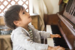 ピアノの音に感動する少年